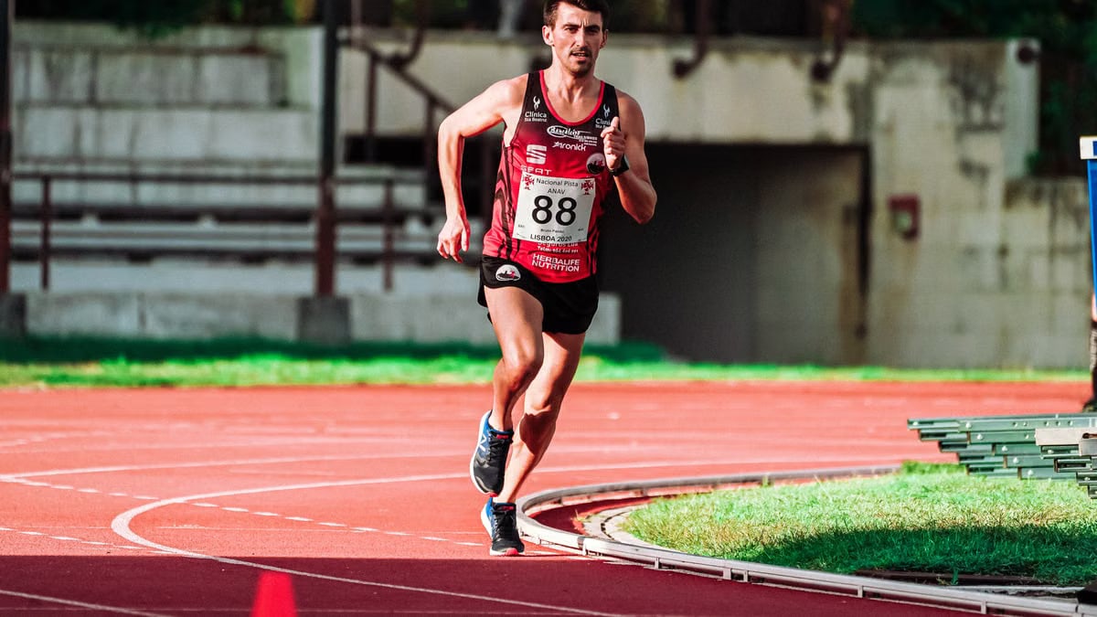 Full body of focused fit sportsman running on track during competition on stadium